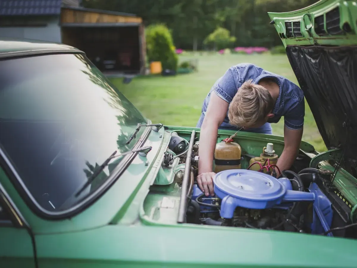 A mechanic inspecting an engine bay